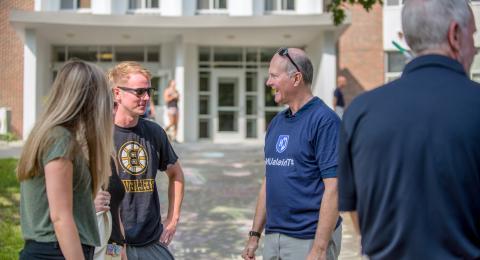 UNH President James Dean with student on campus